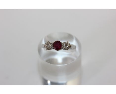 A ruby and diamond three stone ring in 18ct white gold