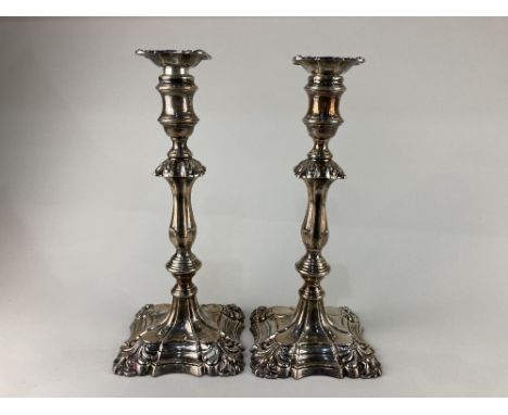 A pair of Victorian silver column candlesticks, maker William Hutton &amp; Sons, London 1894, of scrolling scalloped form, 30
