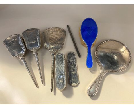 An Elizabeth II silver backed dressing table set, maker Ltd, Birmingham 1953, comprising pair hairbrushes, hand mirror, cloth