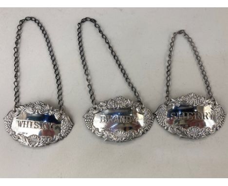 A set of three Elizabeth II silver decanter labels, brandy, whisky and sherry, maker W I Broadway &amp; Co, Birmingham 1989