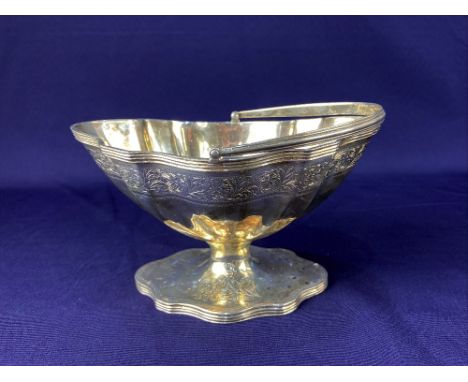 An Edward VII silver sugar basket, makers R &amp; S Garrard &amp; Co, London 1907, of scalloped form with etched floral desig