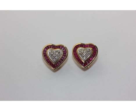 A pair of ruby and diamond ear clips heart shaped with a pave set central cluster