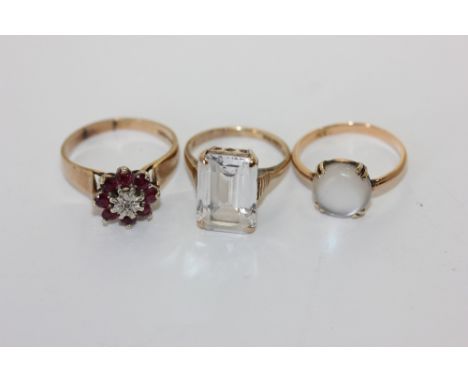 A ruby cluster ring, a moonstone ring and a white quartz ring