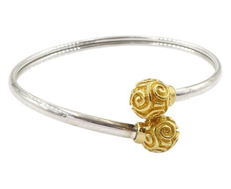 9ct white gold bangle with yellow gold ball finials with swirl decoration, hallmarkedCondition Report:Approx 10.55gm, inner c