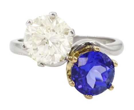 Platinum round brilliant cut diamond and tanzanite crossover ring, Sheffield 2002, diamond 3.01 carat, tanzanite approx 2.50 