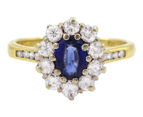 18ct gold oval cut sapphire and round brilliant cut diamond cluster ring, with diamond set shoulders, London 1990, total diam