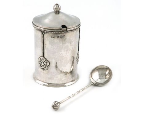 By A. E. Jones, an Edwardian Arts and Crafts silver jam pot and cover with a spoon, Birmingham 1908, the spoon 1918, cylindri