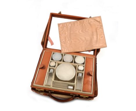 Retailed by Asprey, London, a nine piece silver-mounted travelling dressing table set, maker's mark of AJG, London 1936, the 