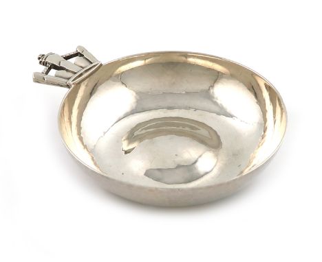 By R. E. Stone, an Arts and Crafts silver wine taster, London 1935, circular form, spot-hammered decoration, with a pierced c