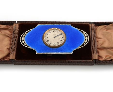 A silver-gilt and blue enamel travelling clock, by Walker and Hall, Birmingham 1927, shaped rounded rectangular form, with a 