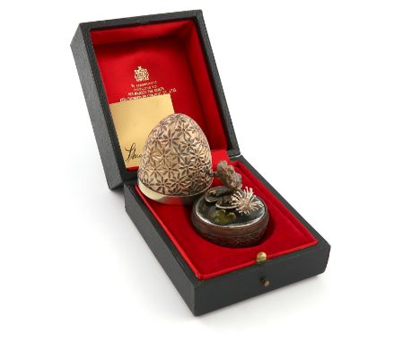 By Stuart Devlin, a modern cased silver-gilt, silver and enamel surprise egg, London 1978, limited edition number 232 of 300,