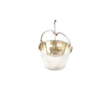 By A. E. Jones, an Arts and Crafts silver cream pail and ladle, Birmingham 1923, the ladle 1927, tapering circular form, fixe