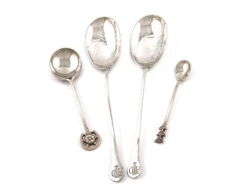 A small collection of four Arts and Crafts silver spoons, comprising: a pair of serving spoons, by Hugh Wallis, Chester 1909,