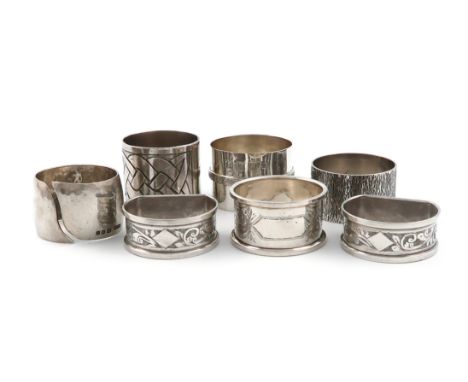 A small collection of seven silver napkin rings, various dates and makers, including: a spot-hammered one by Mid-Essex School