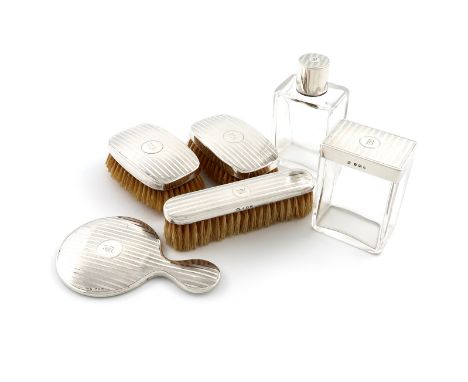 A matched six-piece silver dressing table set, London 1927 and Birmingham 1930 and 1933, with engine-turned decoration, initi