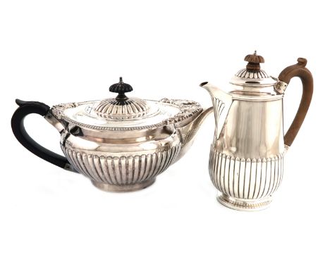 A late-Victorian silver teapot, by Searle &amp; Co, London 1900, circular cape form, foliate shell and gadroon border, leaf c