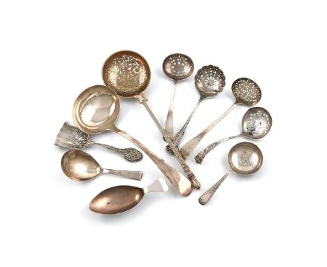 A mixed lot of silver sugar sifting and caddy spoons, various dates and makers, comprising: a French sugar sifting spoon, mak