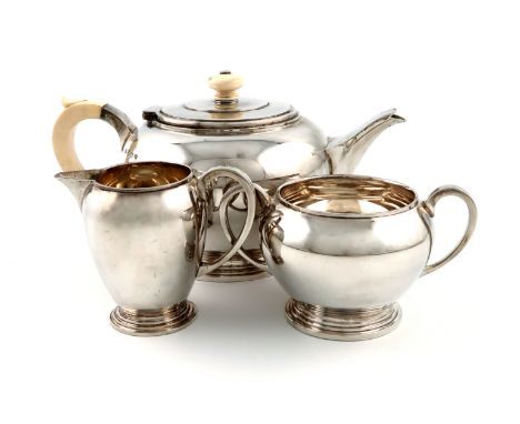 λA three-piece Art Deco silver and ivory tea set, by The Adie Brothers, Birmingham 1935 and 1937, circular form, the teapot w