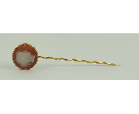 A Carved Cornelian Stick Pin, 20th Century, yellow metal, topped with a carved Cornelian stone in the form of a Roman head, s