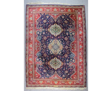 An Eastern Carpet of Tabriz Pattern, woven in colours with central lozenge shaped medallion and two octagonal medallions, on 