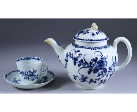 A Worcester Blue and White Porcelain Moulded Cup and Saucer, Circa 1757, with rare handle, painted with "Feather Mould Floral