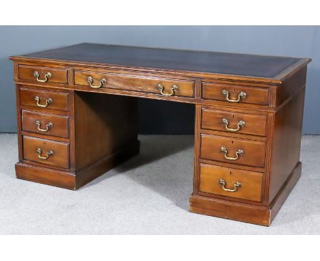 A Late Victorian Mahogany Kneehole Desk, with red tooled leather inset to top, fitted nine  drawers, with fluted uprights on 