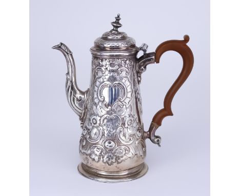 A Georgian Silver Coffee Pot, hallmarks rubbed but thought to be London, the tapered body embossed with scroll and floral orn