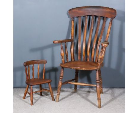 A Child's Stick Back Windsor Chair and a Slat Back Windsor Chair, the child's chair with curved crest rail, wood seat on turn