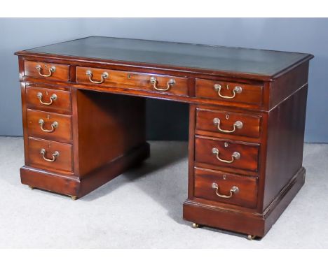 A Victorian Mahogany Kneehole Desk, with green leather inset to top and moulded edge, fitted nine drawers on plinth base, 53i