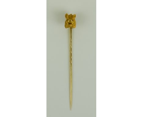 A Stick Pin, Early 20th Century, the finial with yellow metal boar's head on a 14ct gold stick pin, gross weight 8.5g, in fit