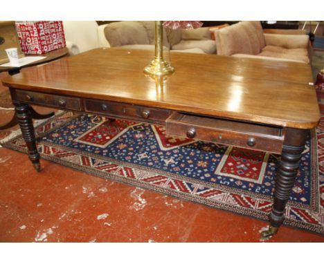  A 19th Century mahogany dining table/library table   with six frieze drawers on ring turned and tapering legs 183cm length 