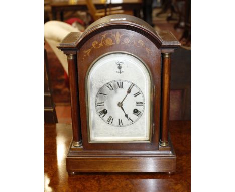  An Edwardian mahogany and inlaid mantel clock   with a silvered dial and silent chime  