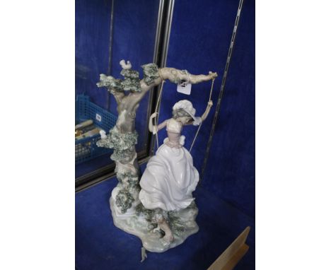  A Lladro figure of a girl swinging from a tree  , 38cm high (af) 