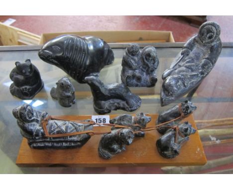  Inuit Sculpture  , ten pieces including a sea lions, beaver, seated Inuit woman. an Inuit in a kayak with a seal, a sled and