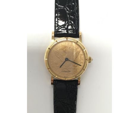 An interesting 18ct gold Corum US ten dollar coin wristwatch, mounted on a black leather strap.