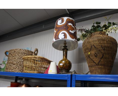 A glazed table lamp; together with a twin handled wicker log basket; one other wicker basket; and a wicker vase and contents 