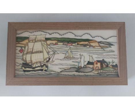 A Moorcroft ceramic framed plaque, Titled Endeavour Whitby, with a sailing ship in harbour.inside frame measurements of the l