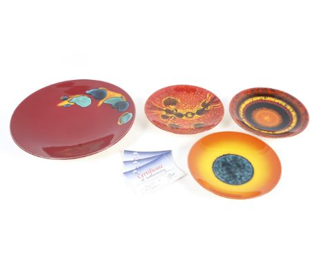A Poole Pottery circular charger and four limited edition plates. The Delphis charger 40.5cm diam., the plates designed by Al