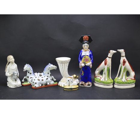 An assortment of ceramics. Including a Nao figure, Coalport vase, pair of Staffordshire dogs etc