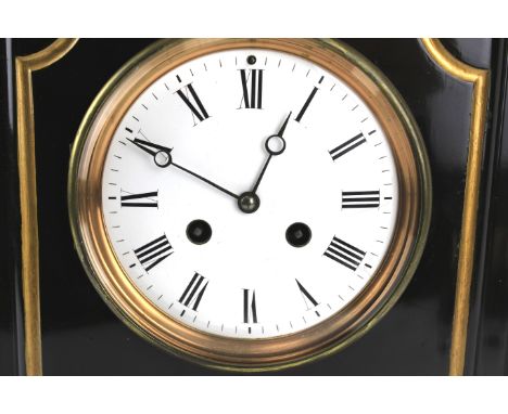 A late Victorian slate striking mantel clock. The white enamelled dial with black Roman numerals, the gilt metal door stamped