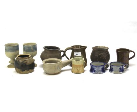 A collection of studio pottery. Including a Stonethrow Pottery cup, a pair of tankards etc
