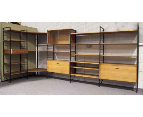 A large Ladderax shelving system. Comprising a corner unit with three shaped shelves, with six black ladder end supports and 