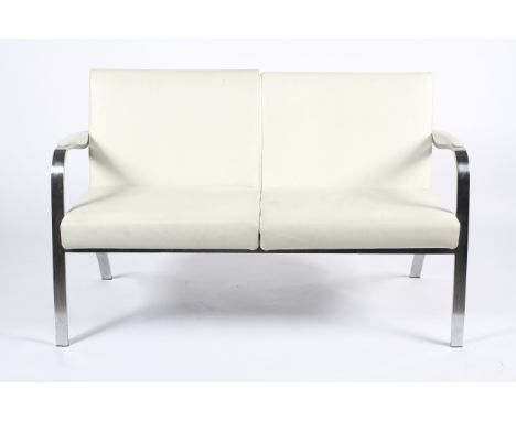 A Brunner two seater sofa and a chair. Each with white leatherette upholstery, on chromed outswept supports, the sofa with ch