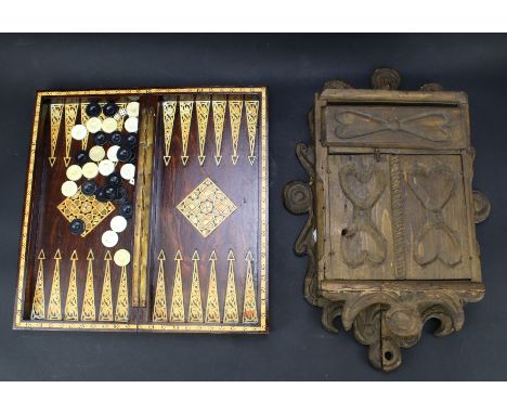 A lacquered folding games box and a loving box. The games box exterior creating a chess board with inlaid details, the interi