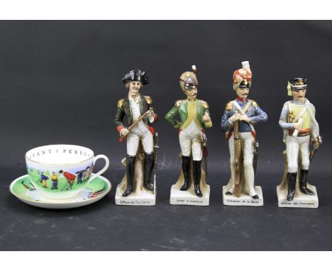 Four ceramic figures of French soldiers and a cup and saucer. The figures dressed in historic French uniforms, the cup and sa