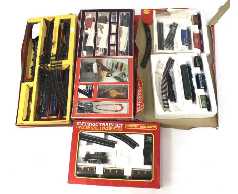 Four boxed OO gauge train sets. Comprising a Hornby 'GWR Branch Passenger Electric Train Set' R.694, Lima 'Car-Unloading Syst