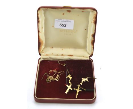 A 9ct gold china and various 9ct gold and yellow metal charms. Including: a 9ct gold crucifix charm, two yellow metal dolphin