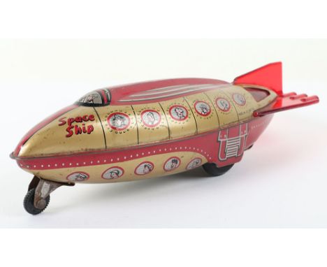 Wells Brimtoy Tinplate Space Ship,  red/gold litho tin body, working gyro friction motor, in good used condition, L 9 ½ ” (24