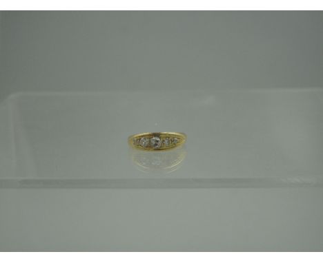 AN EDWARDIAN 18CT GOLD AND DIAMOND RING of five graduated old cut stones.  Ring size K & 1/2 CONDITION REPORT: IGCNOD