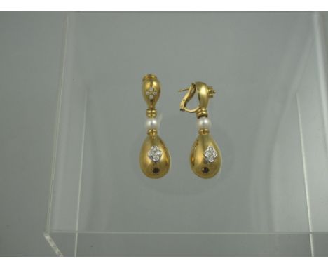 A PAIR OF 18CT GOLD DIAMOND AND PEARL EARRINGS.  The oval pendants set with four brilliant cut diamonds suspended from a pear